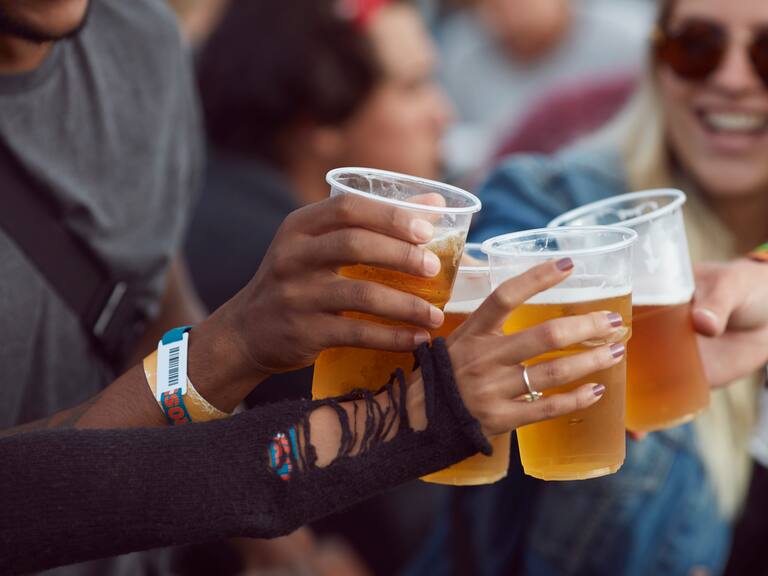 Close-up uf hands toasting in beer, at festival