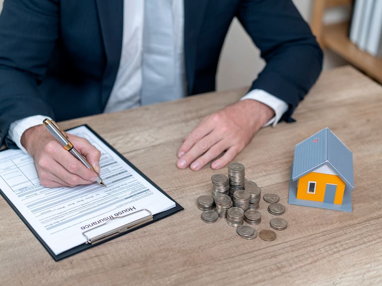 Businessman in suit in his office showing home insurance policy