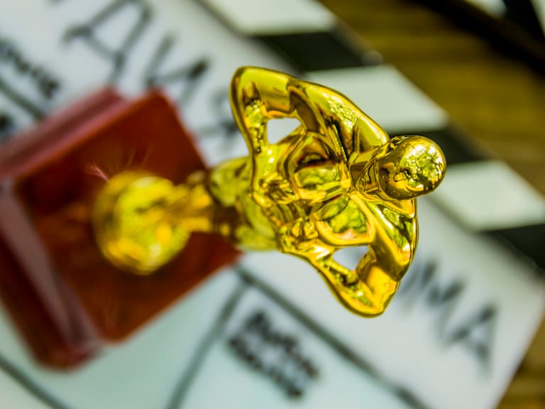 close-up of a decorative oscar figure on blurry film clapper