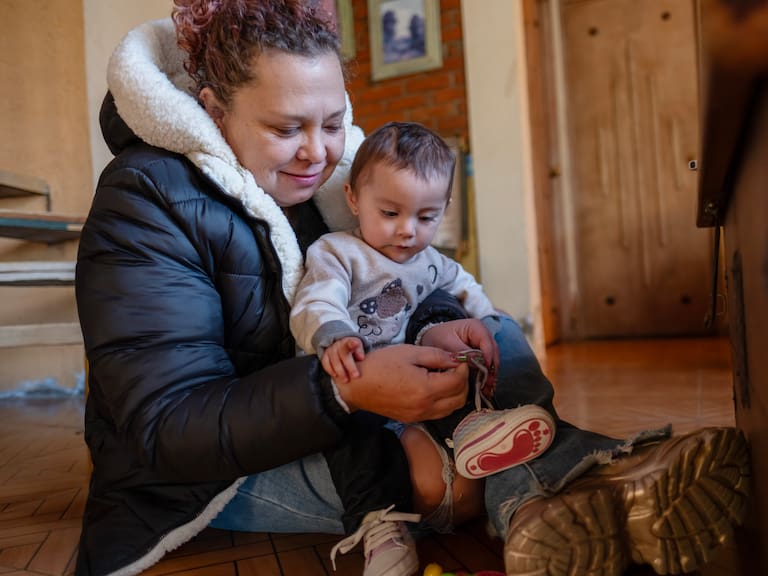 mother caring for her baby while he plays